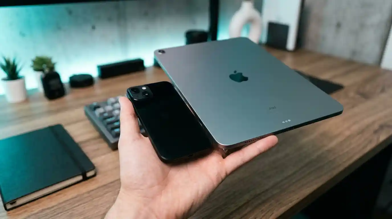 A small compact smartphone next to a larger tablet for scale